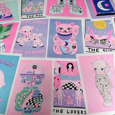 a bunch of pink and blue stickers on top of a white table with pictures