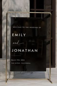 a black and white wedding sign in front of a building