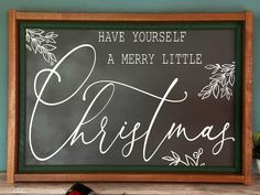 a chalkboard with the words have yourself a merry little christmas written in cursive writing