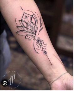 a woman's arm with a flower tattoo on it