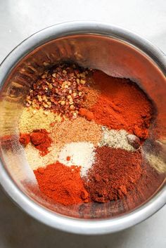 a bowl filled with spices on top of a table