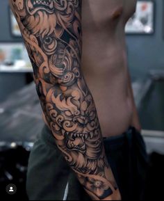 a man with a dragon tattoo on his arm