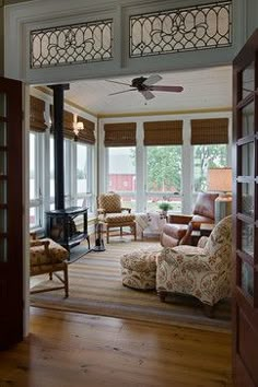 a living room filled with furniture and lots of windows