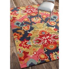 a colorful rug with a chair on the floor