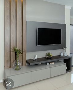 a large flat screen tv mounted to the side of a wall in a living room