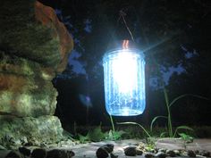 a mason jar hanging from a wire with the words how to make gorgeous colored solar garden lights