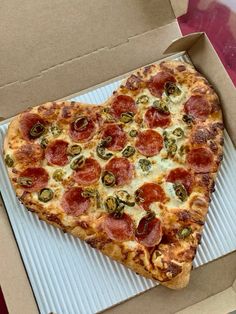 a heart shaped pepperoni pizza in a box