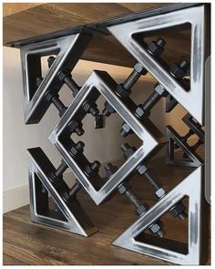 an artistic metal sculpture is shown in the shape of a cube, with multiple pieces of steel