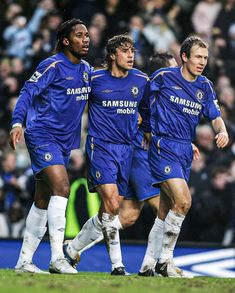 two soccer players are running on the field