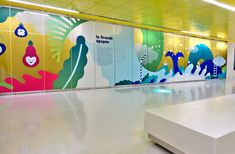 a brightly colored wall in an airport lobby