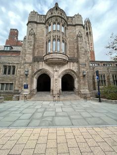 an old building with many windows on the front and side entrance to it is shown