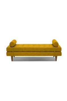 a yellow couch with two pillows on the top and bottom, in front of a white background