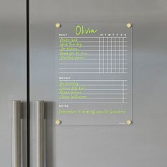 a refrigerator with a sign on the door that says oliva written in green