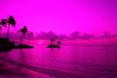 the sun is setting on an island with palm trees in the foreground and purple sky