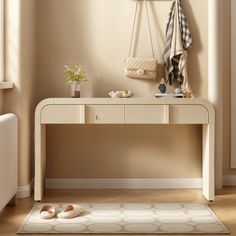 a white table with shoes and purses on it next to a radiator