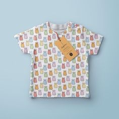 a t - shirt with an orange tag hanging from it's chest on a blue background