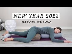 a woman laying on top of a yoga mat with the words new year 209 restorative yoga