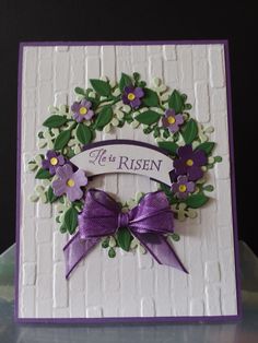 a close up of a card with flowers and a ribbon on the front that says it's risen