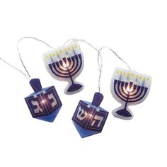 three hanukkah menorah shaped ornaments with lit candles on white background