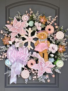 a wreath with pink and white decorations on it