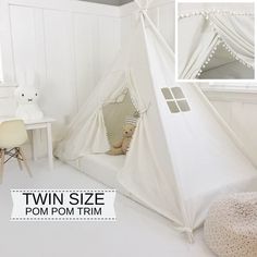 a white teepee tent sitting on top of a bed next to a desk and chair