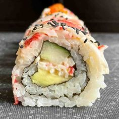 a sushi roll with various toppings on it