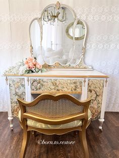 an antique dressing table with mirror and bench in front of wallpapered background,