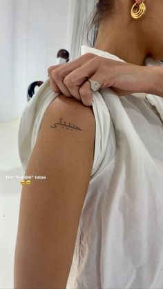 a woman with a tattoo on her arm