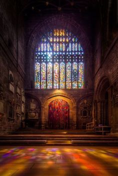 the inside of an old church with stained glass windows