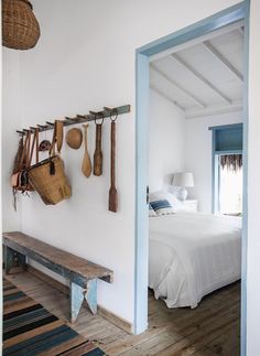 an instagram photo of a bedroom with wooden utensils hanging on the wall