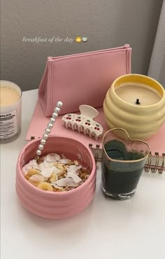 a table topped with two pink bowls filled with food