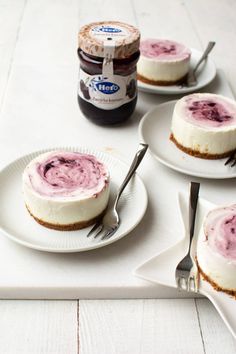 there are four desserts on the table with forks