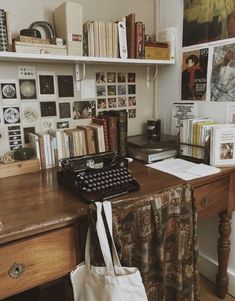 an old fashioned typewriter sitting on top of a wooden desk next to a bookshelf