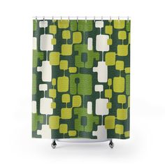 a green and white shower curtain with square shapes on the outside, in front of a white background