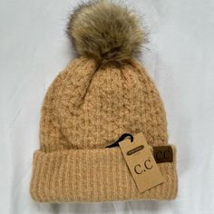 Description: ~ Nwt!! Never Worn ~ Knit Stitch Pattern Beanie With Faux Fur Pom ~ Head Measurements: 57 Cm, 22-3/8", Size 7-1/19. ~ Unisex Knitted Beanie ~ C.C Patch Stitched On Front ~ Color: Peanut ~ Fuzzy Inside ~ 65% Acrylic 12% Nylon 1% Spandex Brown Knit Beanie, Cute Brown Winter Beanie, Trendy Beige Beanie For Fall, Knitted Beanie, Knit Stitch Patterns, Knit Stitch, Pom Beanie, Fur Pom Pom, Knit Beanie