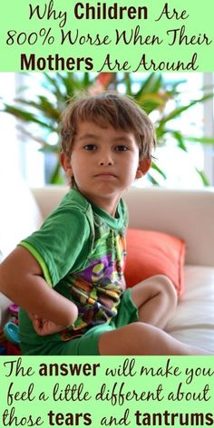 a young boy sitting on top of a white couch next to a potted plant