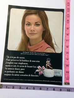 a woman's face is shown on a piece of paper with a measuring tape in front of it