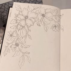 an open book with flowers drawn on it