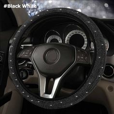 the steering wheel cover is decorated with black beads and sequins on it's sides