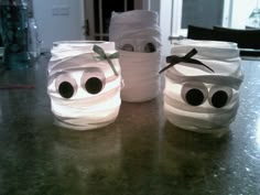 three toilet paper rolls with googly eyes on them