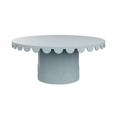 a white table with scalloped edges and a grey base on an isolated white background