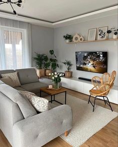 a living room filled with furniture and a flat screen tv