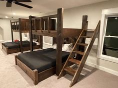 bunk beds with ladders are in the middle of a room