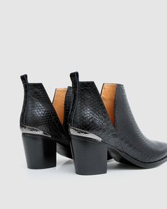 An etched metal capped heel and toe adds a dose of Western styling to the Austin Croc Embossed Ankle Boot. Grounded by a 7cm block heel, the cut-out silhouette and sleek croc embossed leather modernises the classic western features and creates a stylish addition to any outfit. - Genuine leather with croc embossed finish - Cushioned footbed - Cutout side gussets - Gunmetal etched toe and heel detail    If any part gets dirty, we recommend wiping and spot-cleaning them with a soft cloth dampened w Metal Etching, Flats For Sale, Boots For Sale, Black Ankle Boots, New Shoes, Embossed Leather, Heeled Mules, Girls Shoes, Bag Sale