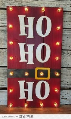 a wooden sign with lights on it that says, oh hohoh and has a santa's hat