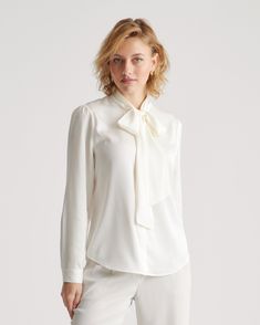 This polished blouse combines the best of both worlds. Wear the ties in a ladylike bow at the neck or leave them long and loose — whatever your mood calls for. Made of our bestselling premium mulberry silk, it has a hint of stretch for a flexible fit. Even better, it’s washable. As a bonus, silk fiber contains 18 kinds of amino acids that make it amazing for skin nourishment, hypo-allergenic, and naturally thermoregulating to help maintain body temperature. White Tie Neck Blouse For Formal Occasions, Elegant Tie Neck Top For Office Wear, Elegant Fall Blouse With Bow Tie, Elegant Bow Tie Top For Spring, Classic Tie Neck Top With Bow, Feminine Tie Neck Tops For Office, Spring Long Sleeve Top With Bow Tie, Feminine Formal Tie Neck Tops, Feminine Tie Neck Formal Tops