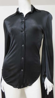 For Sale on 1stDibs - A fabulous black fine stretch silk shirt, top, blouse from Tom Ford for Gucci. It is semi fitted with a shirt collar, black mother of pearl Gucci inscribed Elegant Gucci Blouse For Evening, Elegant Gucci Blouse For Party, Elegant Gucci Party Blouse, Gucci Long Sleeve Evening Tops, Gucci Evening Long Sleeve Tops, Chic Gucci Collared Blouse, Elegant Gucci Office Blouse, Designer Long Sleeve Blouse For Evening, Gucci Black Top For Night Out