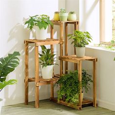 three wooden plant stands with plants in them