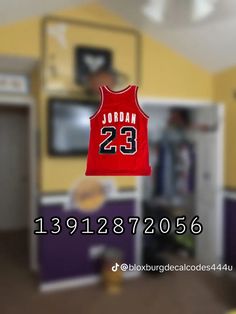 a red basketball jersey hanging from the ceiling