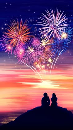 two people sitting on a hill watching fireworks